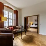 Living room with red sofa and parquet flooring